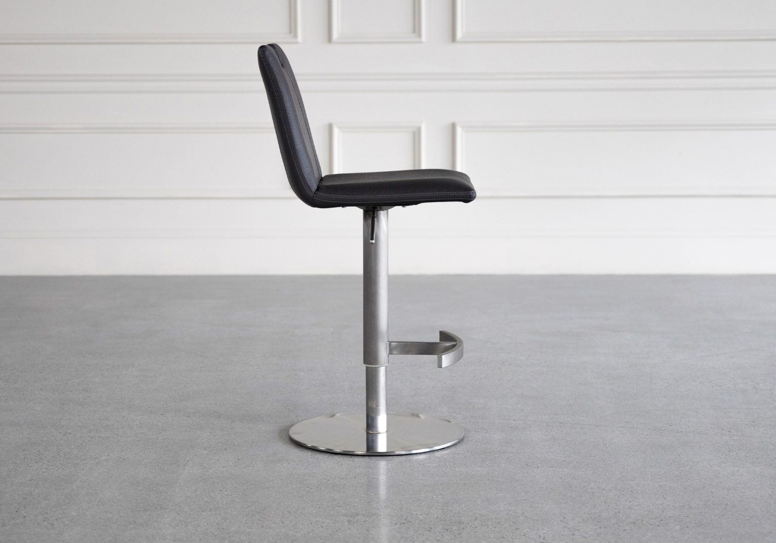 adele black vinyl swivel bar stool side