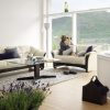 Ekornes® Oslo Sofa in Paloma Light Grey and Wenge Wood, A Lady looking out the Window